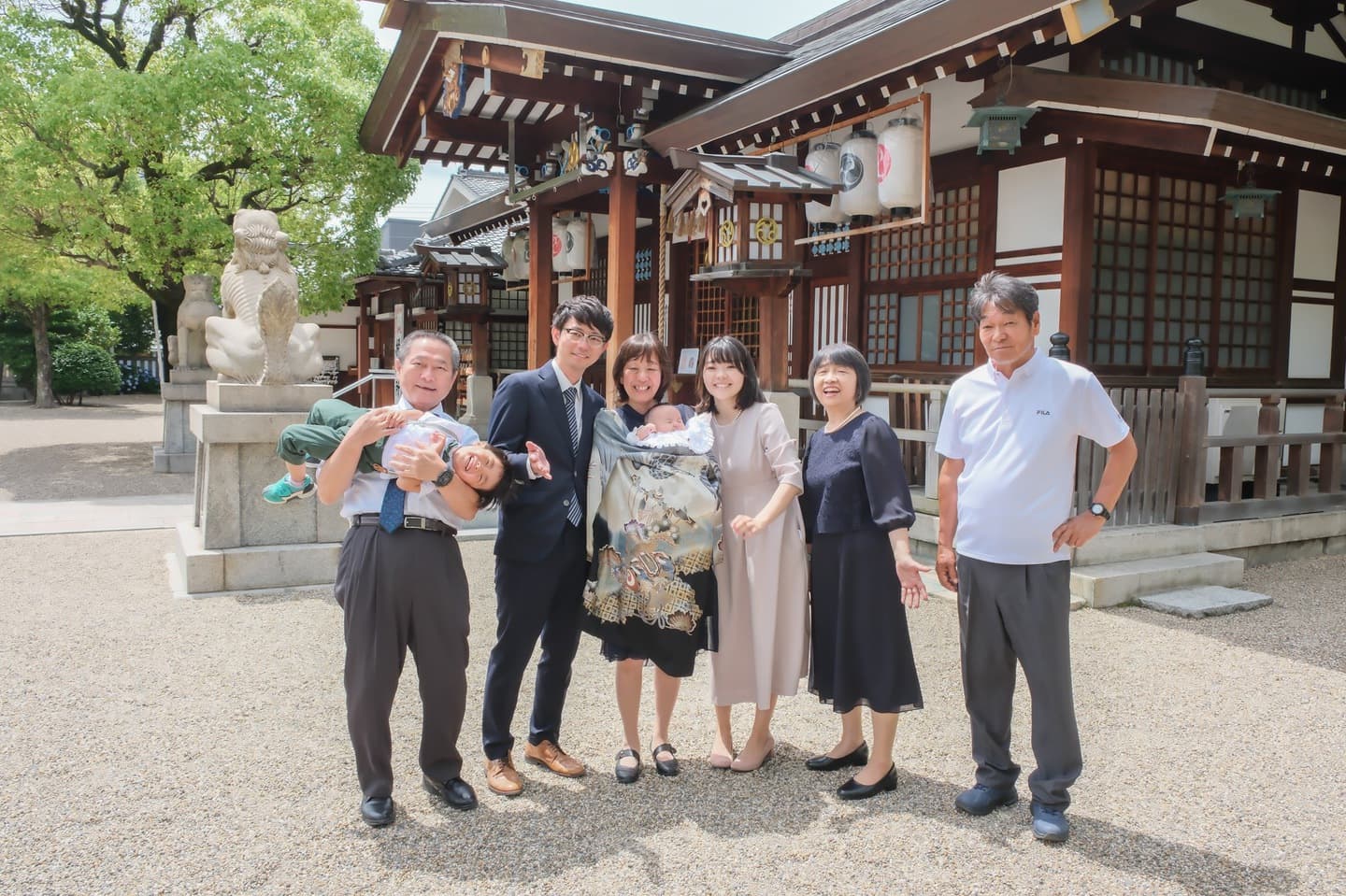 神社でお宮参りの赤ちゃんと家族