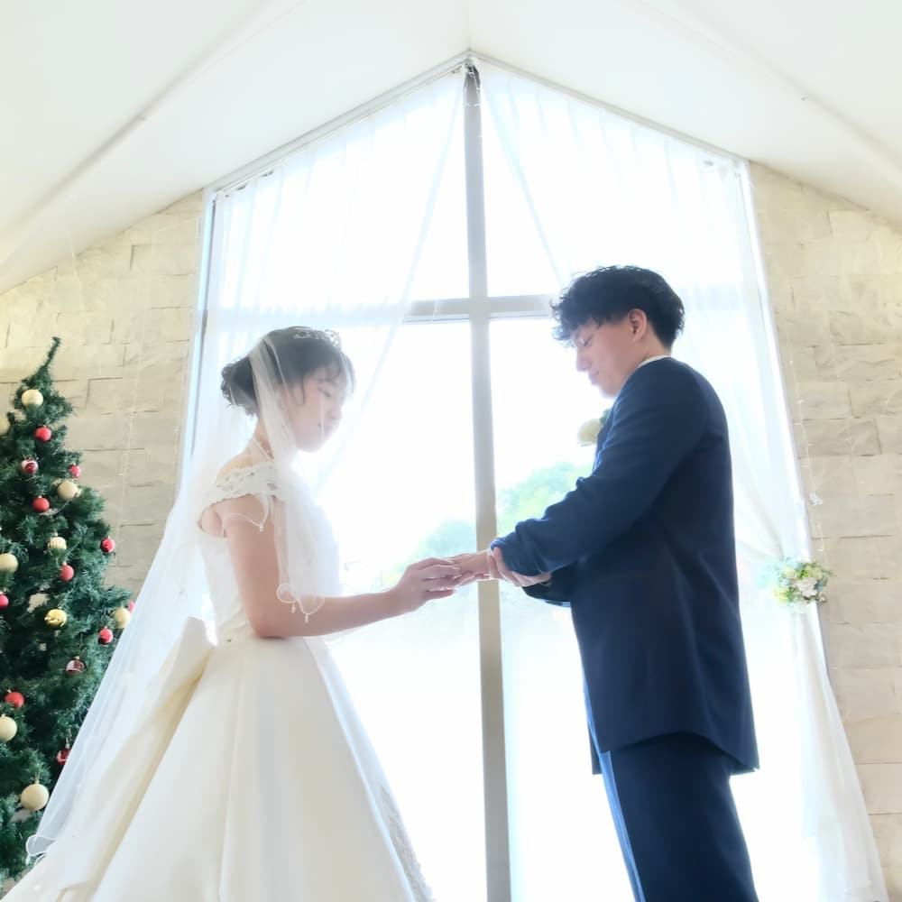 ウェディングを行っているウェディングドレスを着た花嫁様とタキシードを着た新郎様