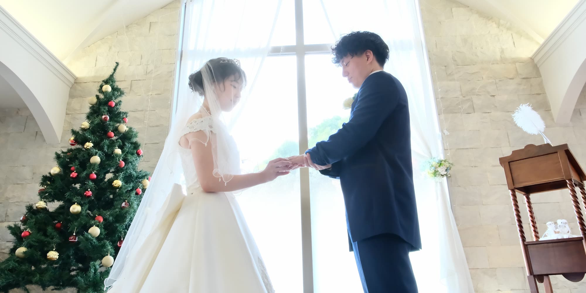 ウェディングを行っているウェディングドレスを着た花嫁様とタキシードを着た新郎様
