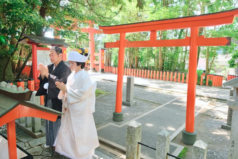 白無垢の花嫁様と紋付羽織袴の新郎様が結婚式を挙げている