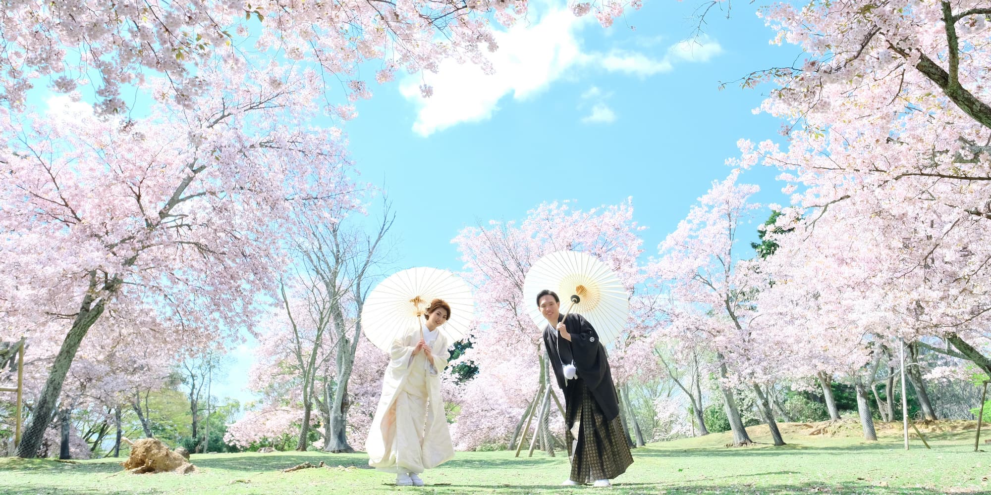 白無垢を着た花嫁様と紋付羽織袴を着た新郎様が神社で結婚式を挙げている