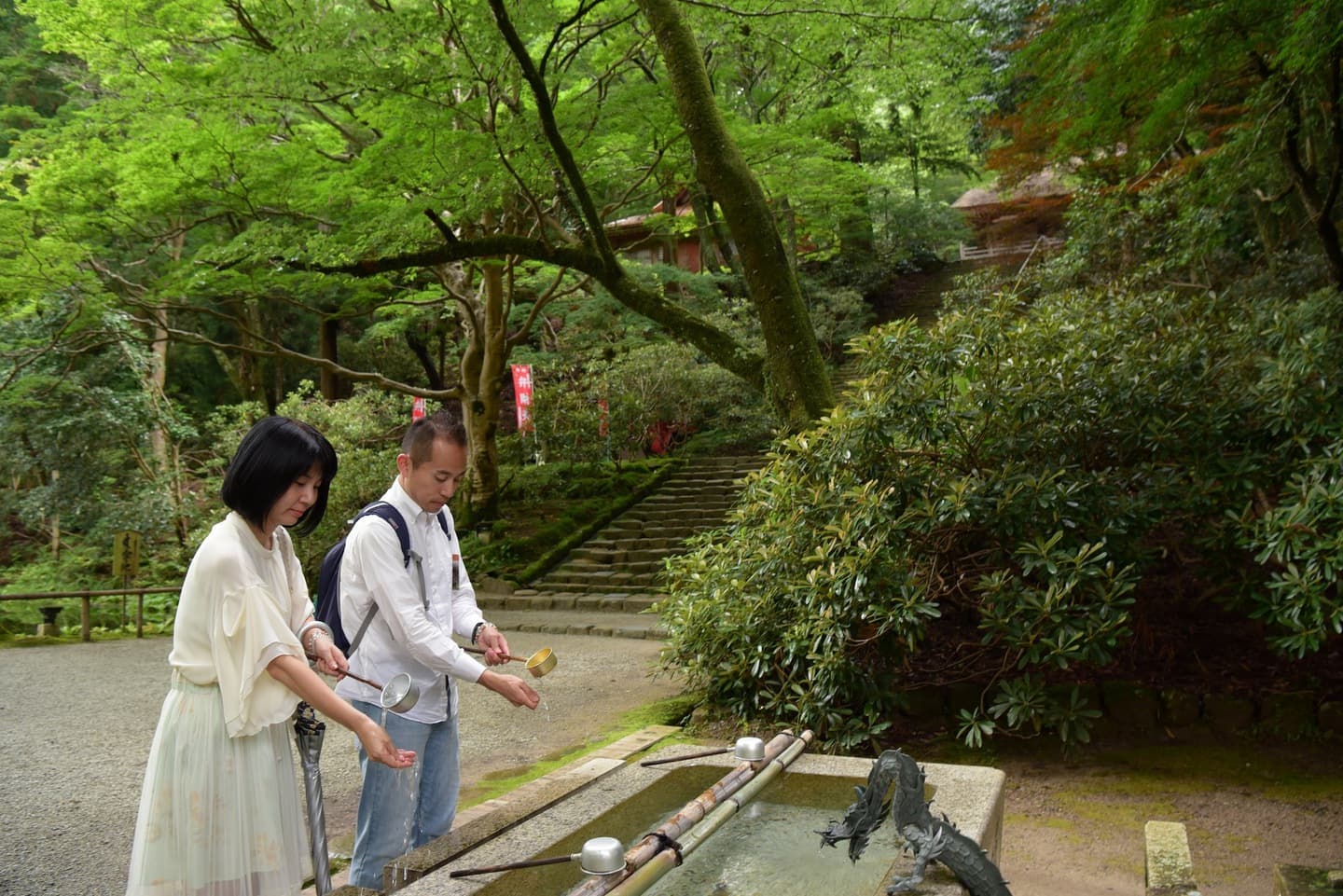 神社で手水をする夫婦